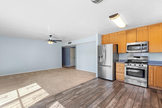 kitchen with ceiling fan, baseboards, stainless steel appliances, and dark wood-style flooring