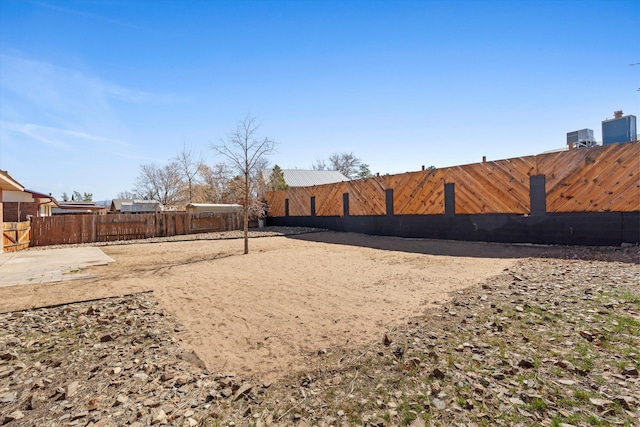 view of yard featuring volleyball court, central AC unit, and fence