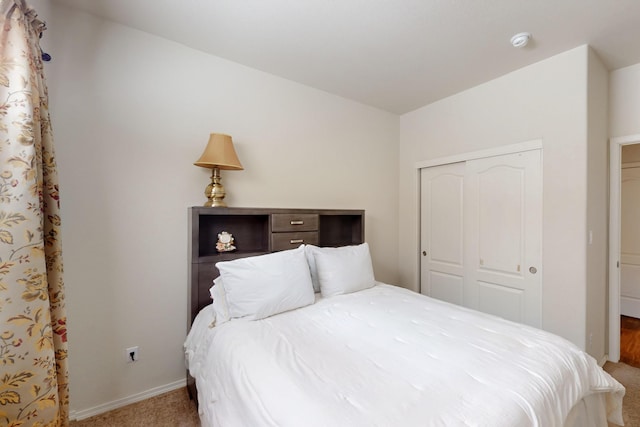 bedroom featuring a closet, carpet, and baseboards