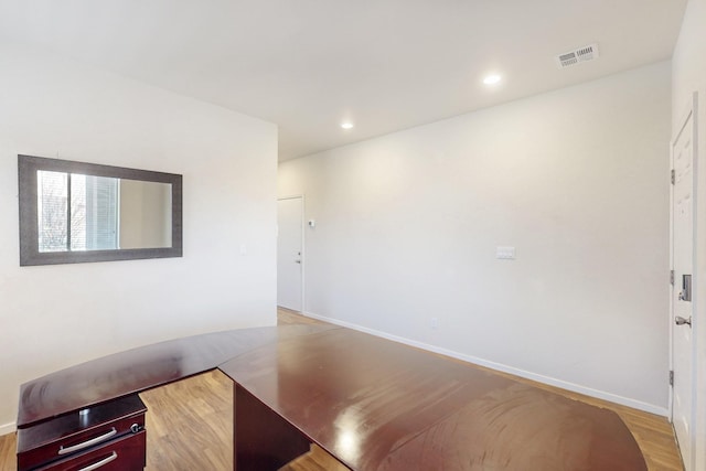 interior space with baseboards, wood finished floors, visible vents, and recessed lighting