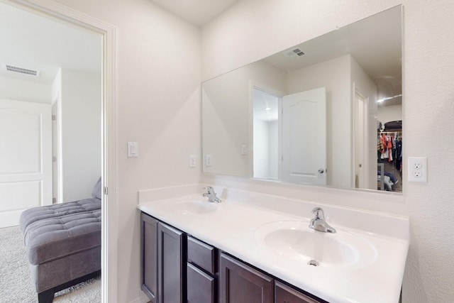 full bathroom featuring double vanity, visible vents, and a sink