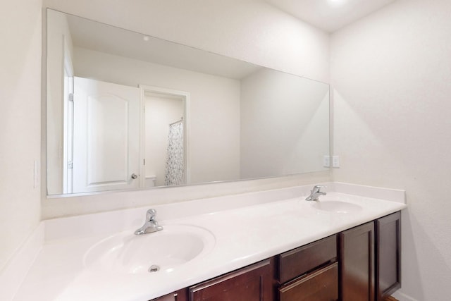 bathroom featuring double vanity and a sink