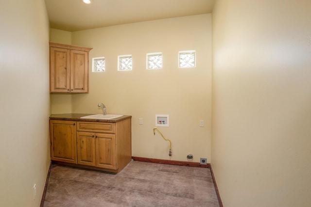 laundry area featuring baseboards, gas dryer hookup, hookup for a washing machine, cabinet space, and a sink