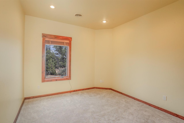 carpeted spare room with recessed lighting, visible vents, and baseboards