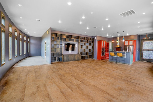 unfurnished living room with visible vents, recessed lighting, and light wood-style floors