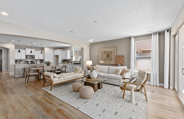 938 Lazuli Rd SE, Rio Rancho, NM 87124 - living room featuring a healthy amount of sunlight, baseboards, and light wood-style floors