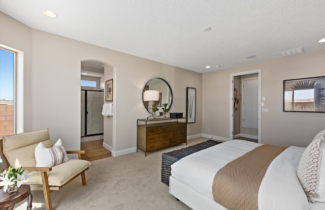 938 Lazuli Rd SE, Rio Rancho, NM 87124 - bedroom with baseboards, visible vents, arched walkways, a textured ceiling, and carpet flooring