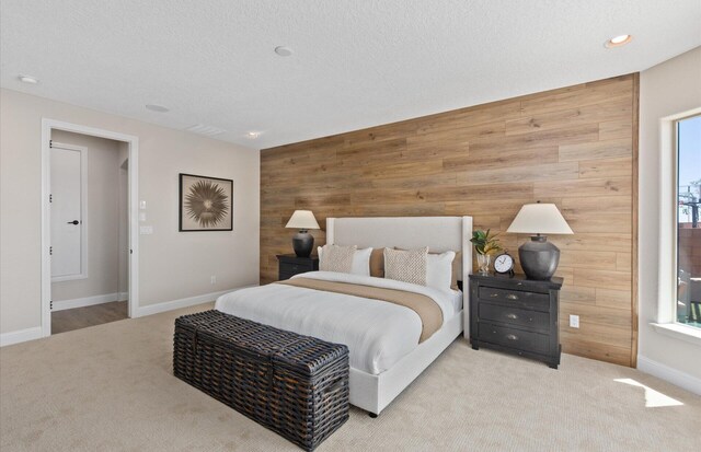 938 Lazuli Rd SE, Rio Rancho, NM 87124 - carpeted bedroom featuring wood walls, a textured ceiling, an accent wall, and baseboards
