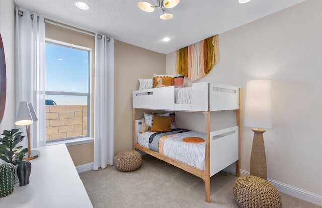 938 Lazuli Rd SE, Rio Rancho, NM 87124 - bedroom featuring recessed lighting, light colored carpet, baseboards, and a textured ceiling