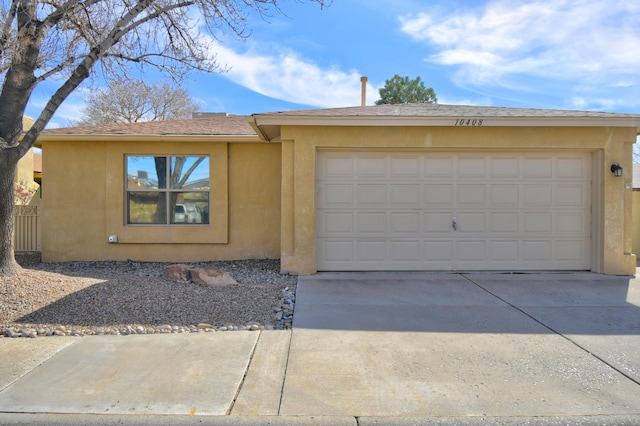 ranch-style house featuring a garage, driveway, and stucco siding