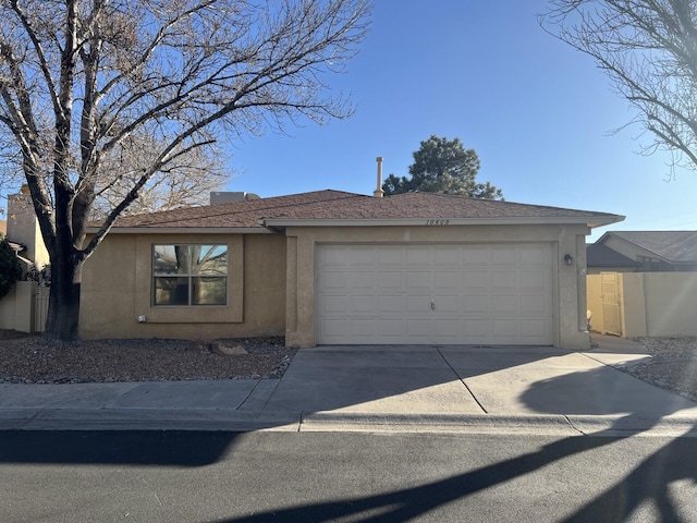 view of front of home with a garage, concrete driveway, and stucco siding