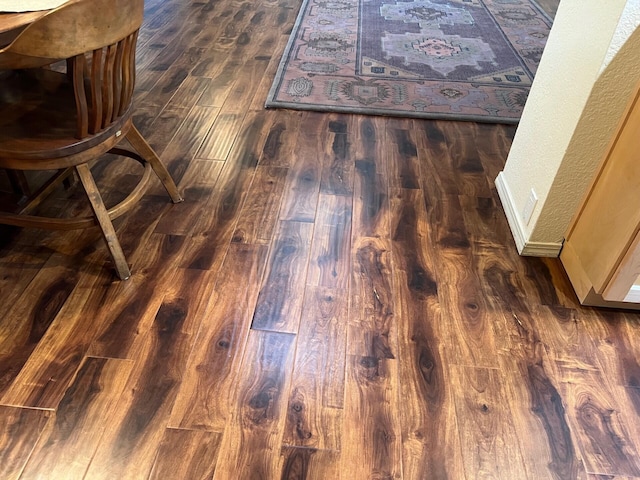 room details with baseboards and wood finished floors