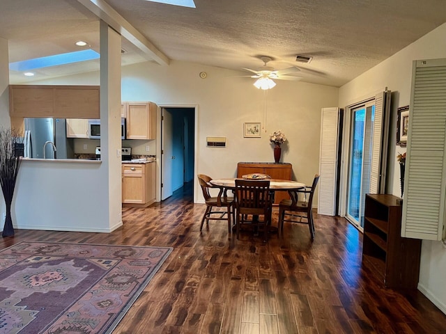 dining room featuring dark wood-style flooring, visible vents, vaulted ceiling with beams, and a textured ceiling