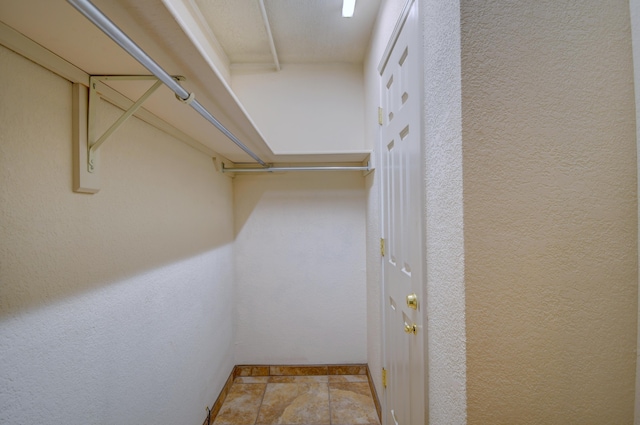 bathroom featuring a marble finish shower