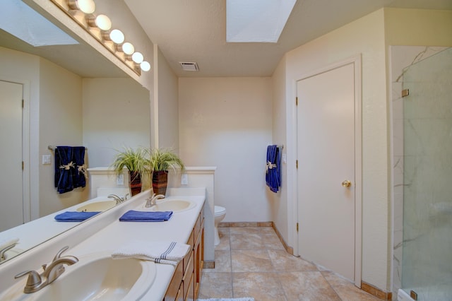 bathroom featuring a skylight, visible vents, and a sink