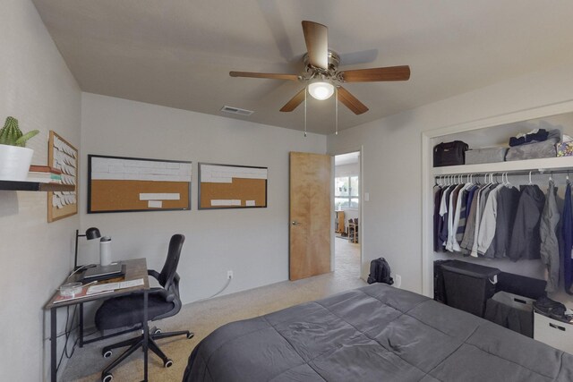 bedroom with carpet floors, a closet, visible vents, and a ceiling fan