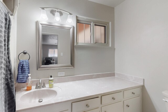 bathroom with toilet and vanity