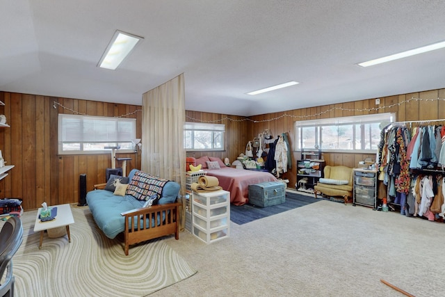 bedroom featuring carpet and wooden walls