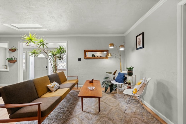 living room with a textured wall, a skylight, crown molding, and baseboards