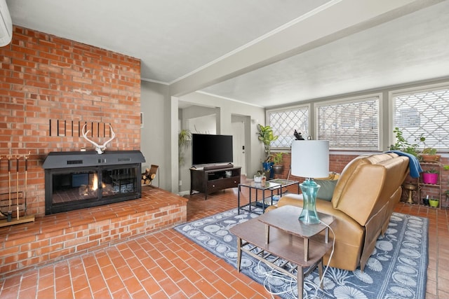 living room with ornamental molding, a glass covered fireplace, and an AC wall unit