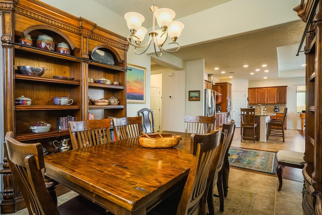 dining room featuring a textured ceiling, light tile patterned floors, recessed lighting, and a chandelier