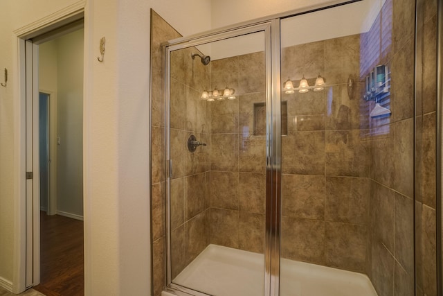 2721 Redondo Santa Fe Loop NE, Rio Rancho, NM 87144 - bathroom with baseboards, wood finished floors, and a shower stall
