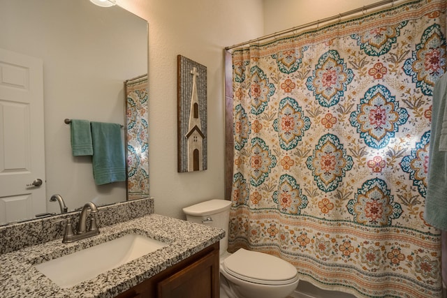 bathroom with vanity, a shower with shower curtain, and toilet