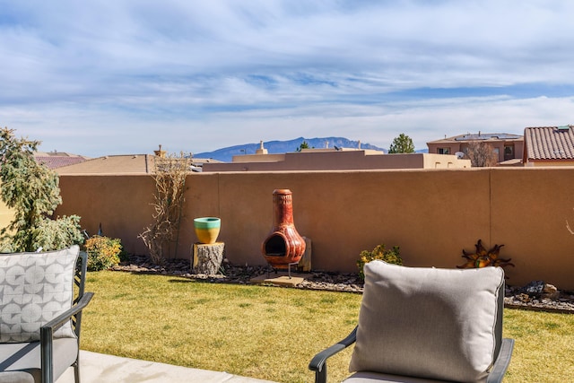 2721 Redondo Santa Fe Loop NE, Rio Rancho, NM 87144 - view of yard featuring fence, a patio area, and a mountain view