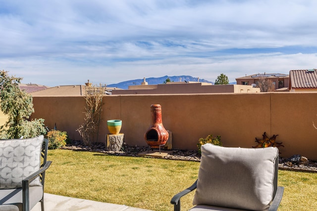 view of yard with a mountain view and fence