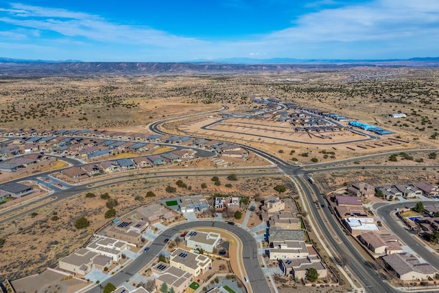 bird's eye view featuring a desert view, a mountain view, and a residential view