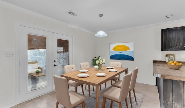 dining area with visible vents, ornamental molding, and french doors