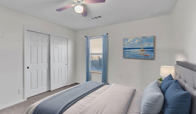 bedroom featuring a closet, carpet, visible vents, and baseboards