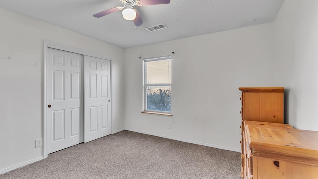 unfurnished bedroom with carpet floors, baseboards, and visible vents