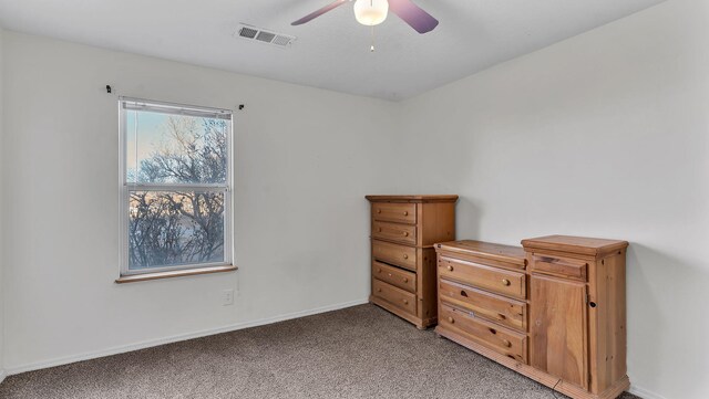 20 2nd St NE, Rio Rancho, NM 87124 - unfurnished bedroom with light colored carpet, visible vents, ceiling fan, and baseboards