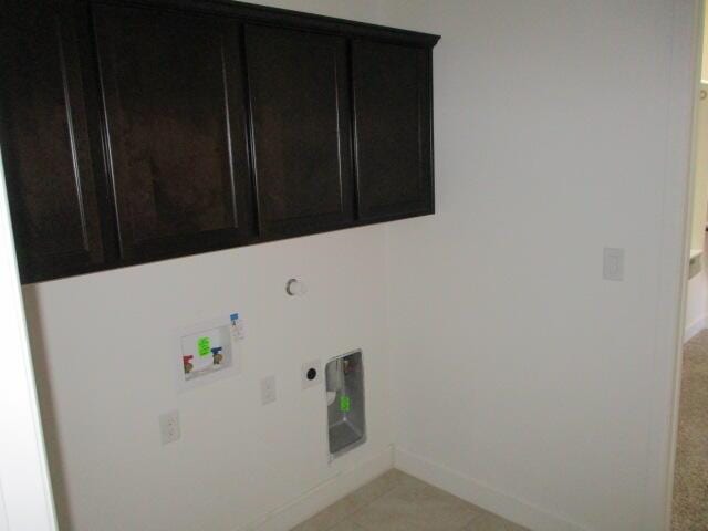 washroom featuring hookup for a washing machine, cabinet space, electric dryer hookup, and baseboards