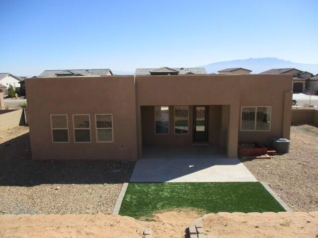 back of property with a patio area and stucco siding