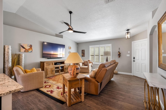 living room featuring dark wood-style floors, ceiling fan, arched walkways, and vaulted ceiling