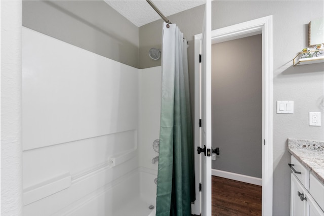 bathroom featuring baseboards, vanity, a shower with shower curtain, and wood finished floors