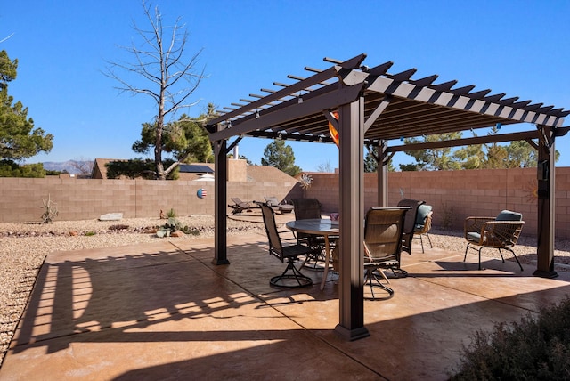 view of patio / terrace with outdoor dining area, a fenced backyard, and a pergola