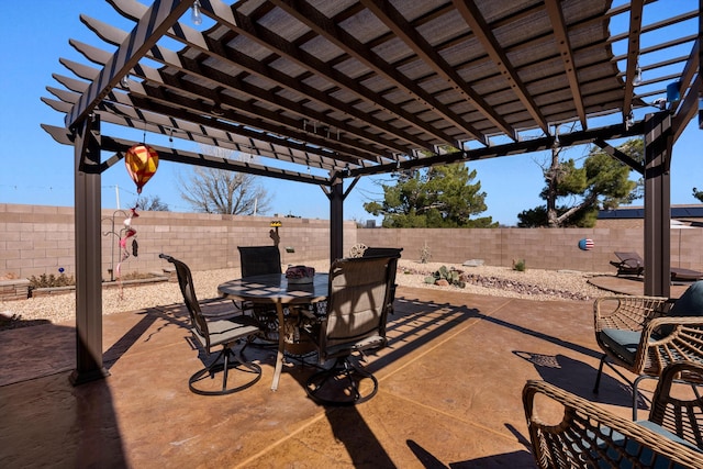 view of patio with a fenced backyard, outdoor dining area, and a pergola