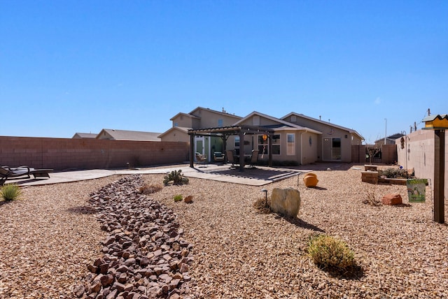 back of property with a patio area, a fenced backyard, and a pergola