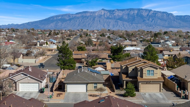 drone / aerial view featuring a residential view and a mountain view