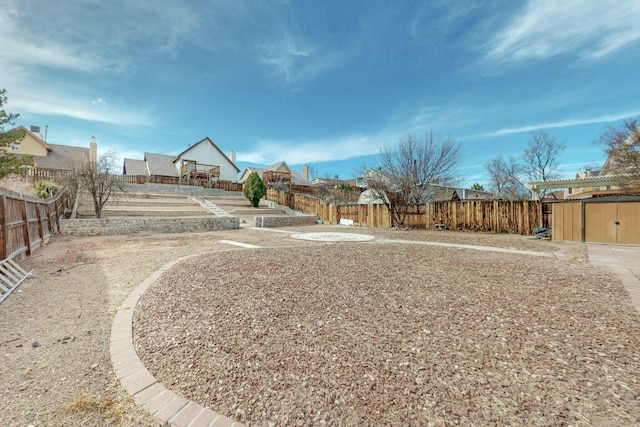 view of yard with a storage shed, an outdoor structure, and a fenced backyard