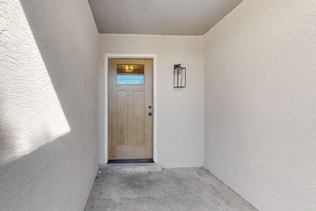 doorway to property with stucco siding