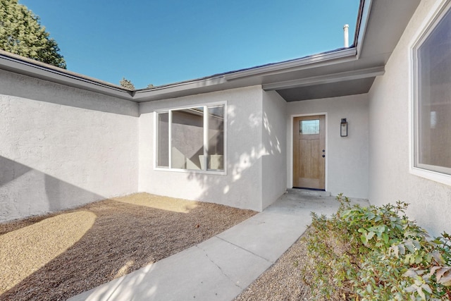 entrance to property with stucco siding