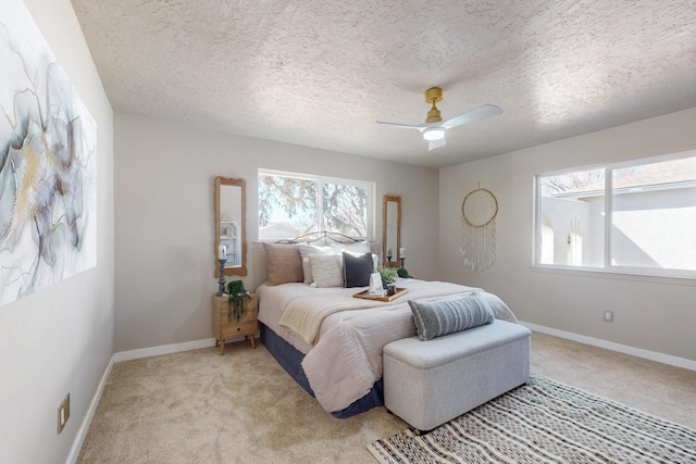 bedroom with a ceiling fan, light colored carpet, and baseboards