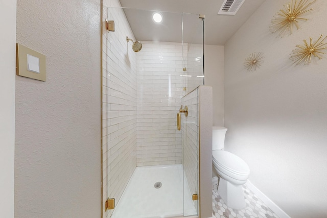 bathroom with visible vents, a shower stall, and toilet