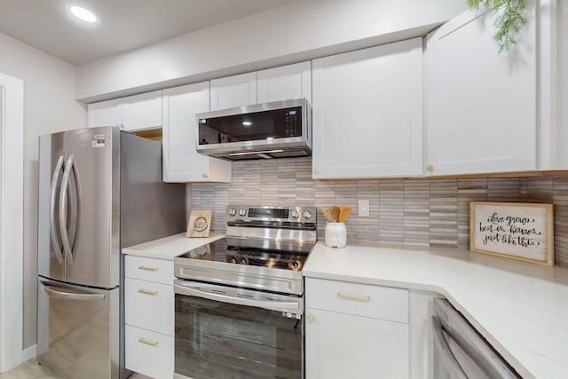 kitchen featuring recessed lighting, light countertops, appliances with stainless steel finishes, white cabinetry, and tasteful backsplash