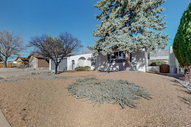 view of front facade with an attached garage and stucco siding