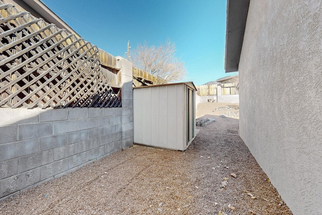 view of yard with an outbuilding, a shed, and fence